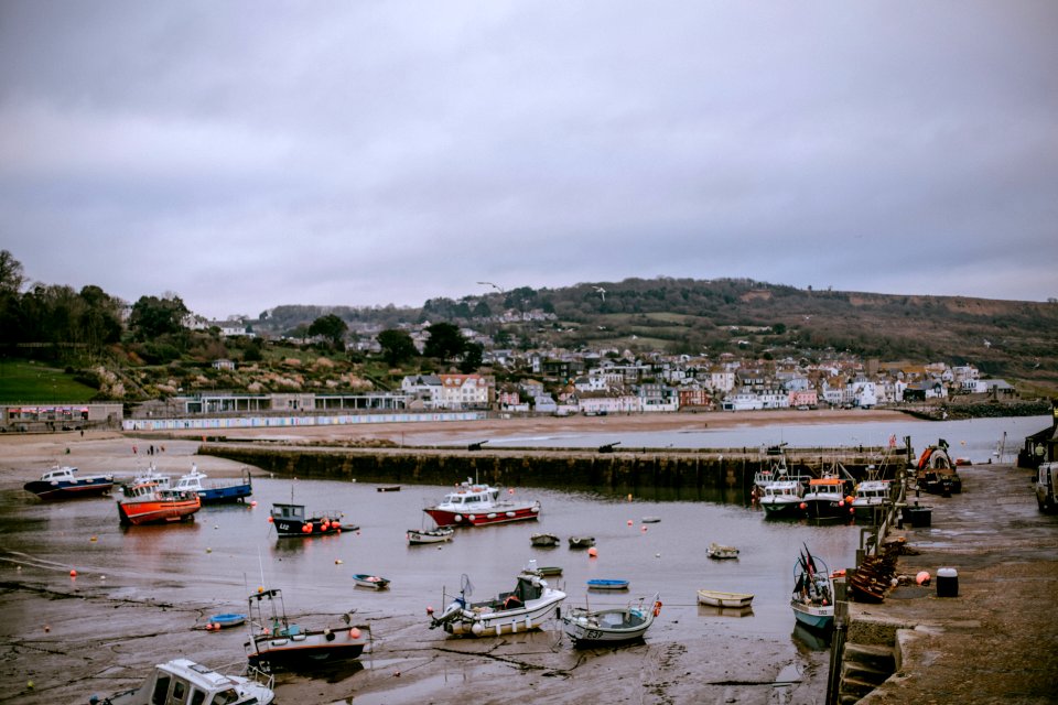 Boats On Water Near Concrete Bridge