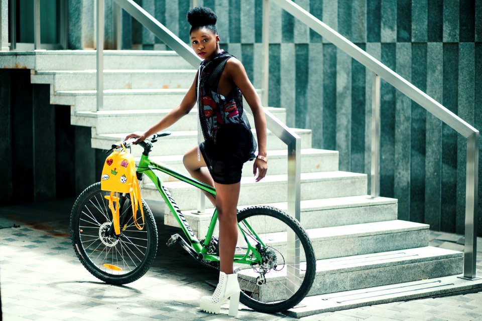 Woman Wearing Black Dress Riding Bicycle Near Stairs