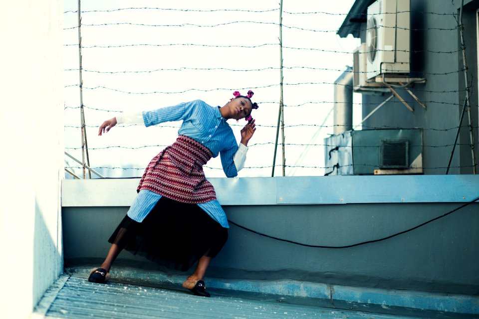 Woman In Blue Button-up Long-sleeved Top And Black Skirt