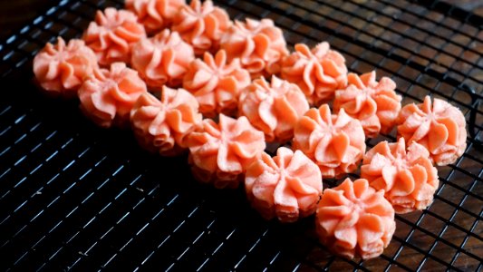 Close-up Photo Of Pink Icing On Black Screen