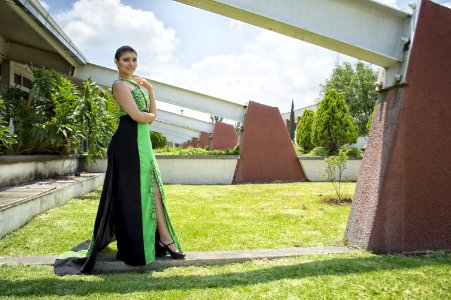 Woman In Green And Black Dress Standing In Front Of Wall photo