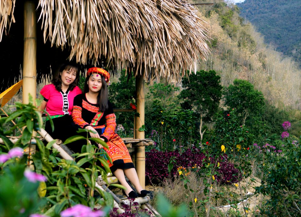 Person In Traditional Dress Sitting On Hut