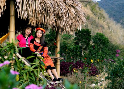Person In Traditional Dress Sitting On Hut