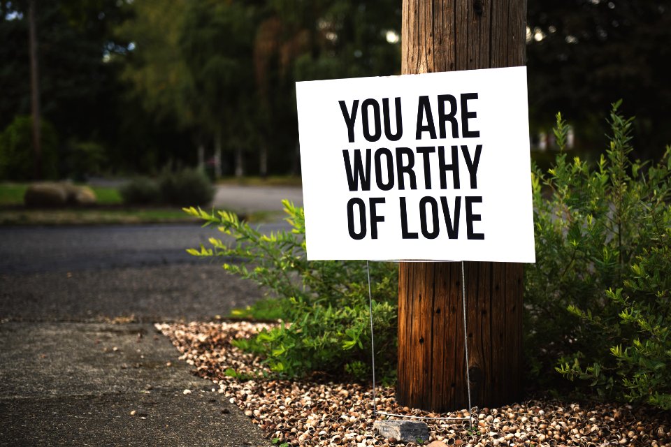 You Are Worthy Of Love Signage On Brown Wooden Post Taken
