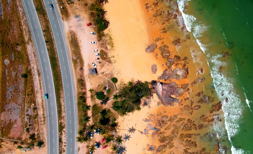 Aerial Photo Of Seashore Near Two Lanes Of Wide Road