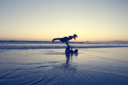 Landscape Photography Of Man Lifting Woman By His Foot On Seashore