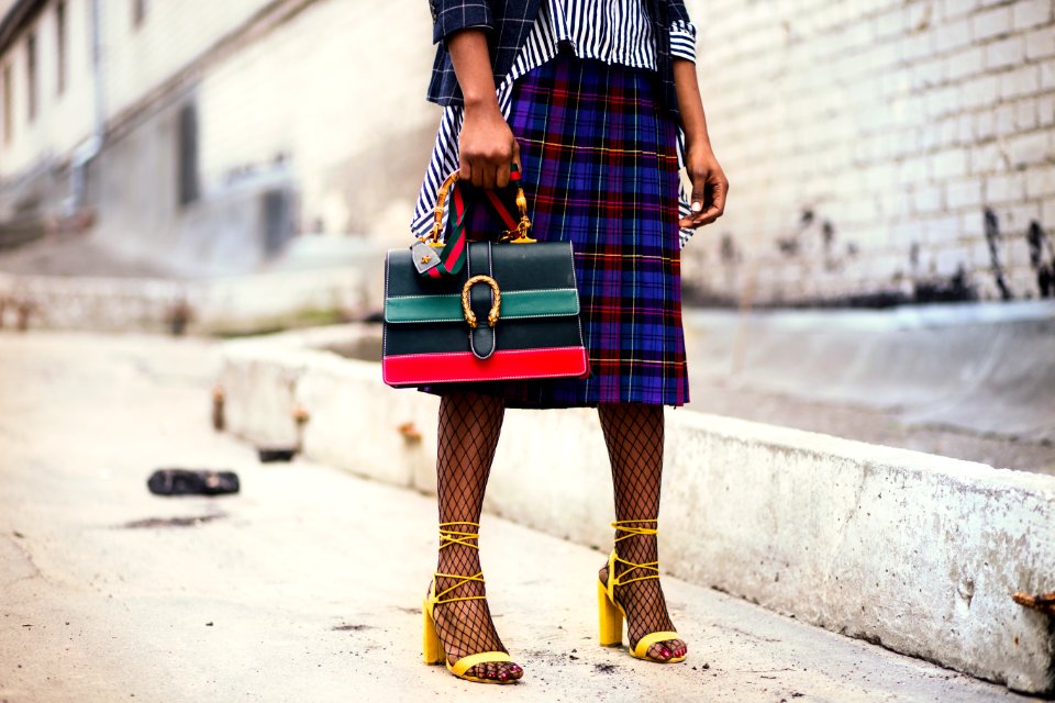 Woman Holding Green And Red Leather Handbag