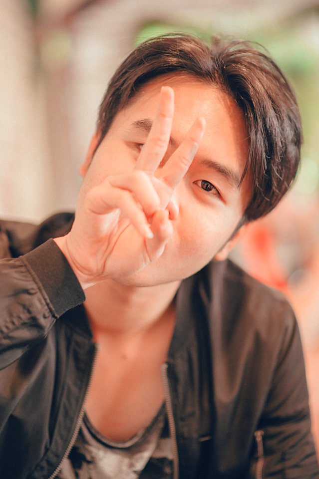 Man In Black Leather Zip-up Jacket Showing Peace Sign