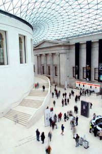 People Waling Inside White Concrete Building photo