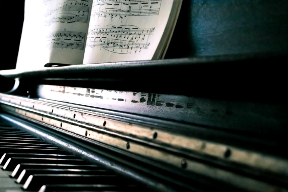 Music Sheet On Black Piano