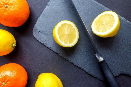 Two Orange And Three Lemons On Gray Surface photo