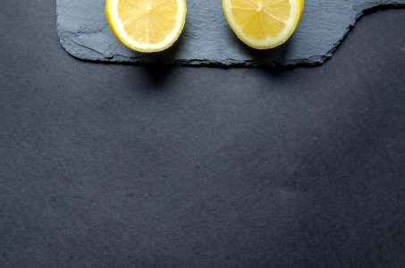 Two Sliced Lemons On Black Surface photo