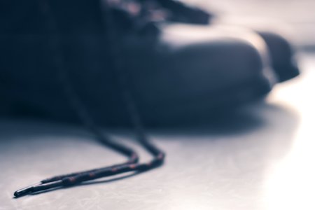 Black Shoelace Placed On Gray Floor photo