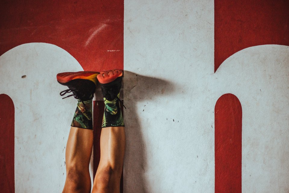 Closeup Photo Of Person Wearing Black-and-red Low-top Sneakers