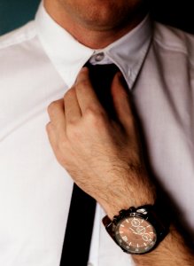 Person Wearing White Dress Shirt Holding Black Necktie photo