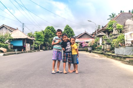 Three Boys Standing On Road photo