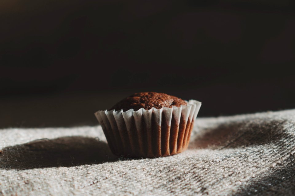 Still Life Photography Of Muffin On White Textile