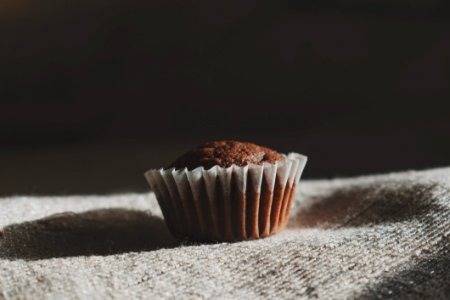 Still Life Photography Of Muffin On White Textile
