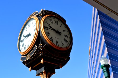 Close-up Photo Of Street Clock Near Tall Building photo