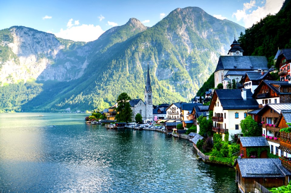 Houses Beside Body Of Water And Mountains At Daytime photo