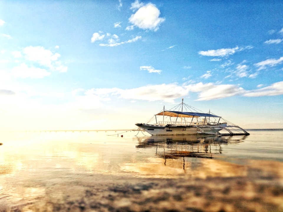 White Boat On Sea During Sunrise