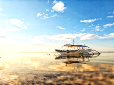 White Boat On Sea During Sunrise photo