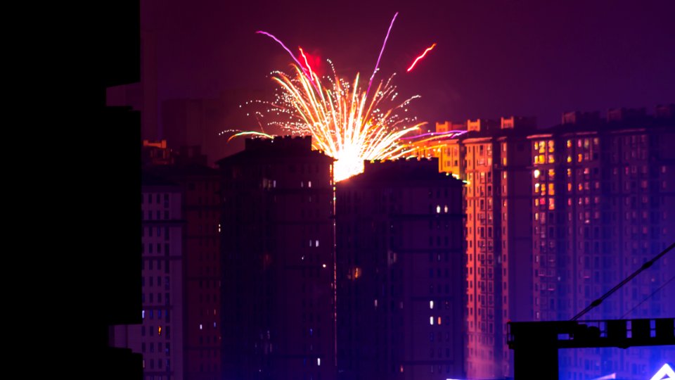 Fireworks Display Near High Rise Buildings During Nighttime photo