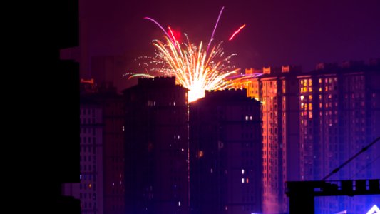 Fireworks Display Near High Rise Buildings During Nighttime
