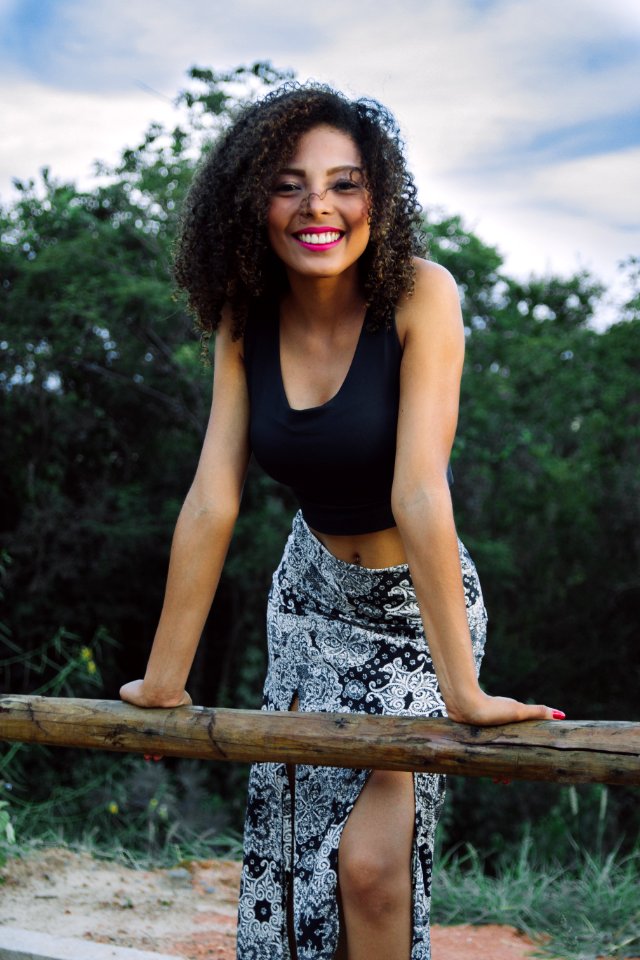 Woman Wearing Black Tank Tops And Gray Floral Asymmetrical Long Skirt photo