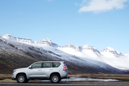 Gray Sports Utility Vehicle On Road Near Snow Covered Mountain photo