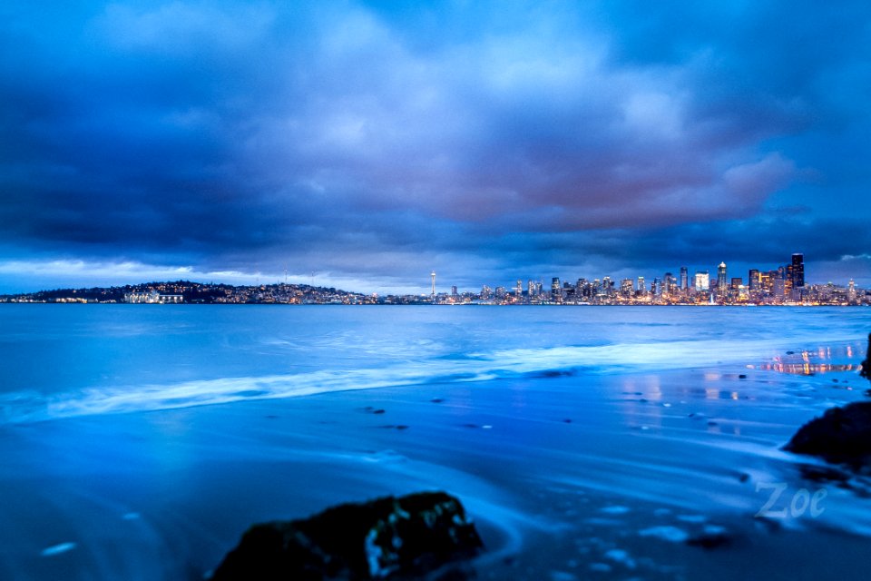City Buildings Near Body Of Water Under Gray Clouds