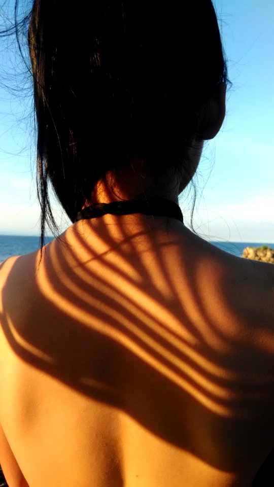 Woman Standing In Front Of Body Of Water