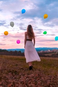 Woman In White Dress Looking At The Balloons photo