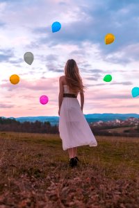 Woman In White Dress Looking At The Balloons