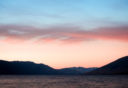 Body Of Water With Mountains On Side photo