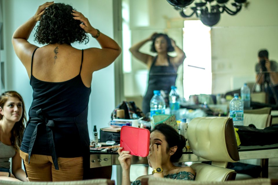 Woman In Black Spaghetti Strap Top Beside Woman Sitting Holding Pink Mirror