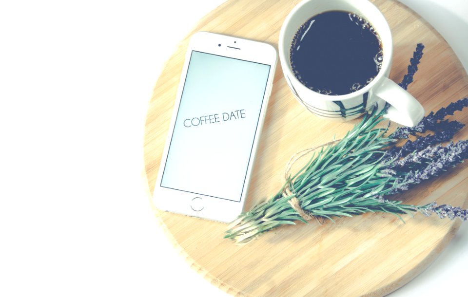 Iphone Beside Coffee And Flower