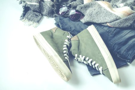 Green High-top Sneakers Beside Bottoms And Sunglasses photo