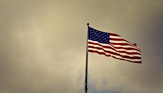 Photo Of Cloudy Skies Over American Flag photo