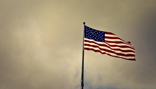 Photo Of Cloudy Skies Over American Flag