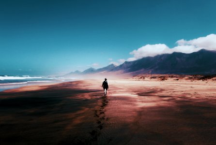 Photo Of Person Walking On Deserted Island photo