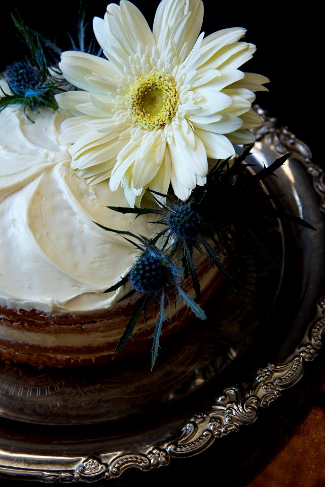 White Flowers On Round Cake With White Cream