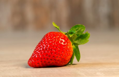 Strawberry Fruit On Brown Wooden Surface photo