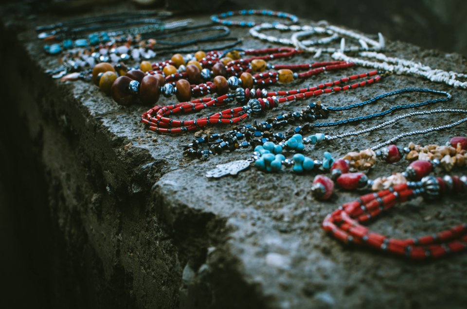 Close Up Photo Of Beaded Accessories On Gray Surface