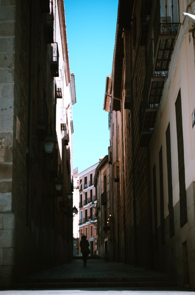 Person Walking Between Of Houses photo