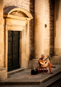 Man Sitting On Chair While Playing Guitar photo