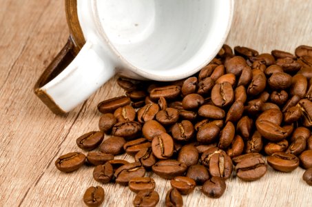 Coffee Beans Beside White And Brown Ceramic Mug photo