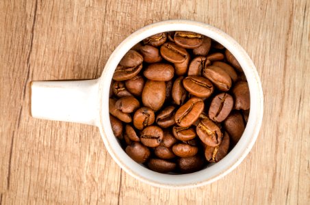 Roasted Coffee Beans Inside White Ceramic Mug photo