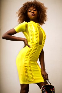 Curly Haired Woman In Yellow Bodycon Dress photo