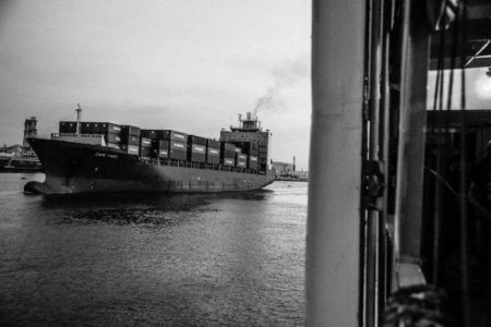 Greyscale Photo Of Cargo Ship On Ocean photo